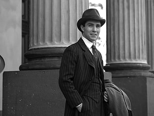 grayscale photo of man wearing suit