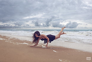 woman lifting herself on shore near beach