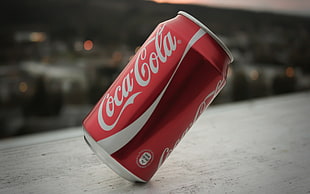 balanced Coca-Cola can on white surface HD wallpaper