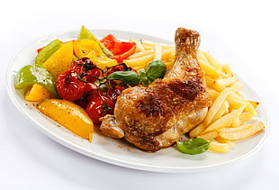 fried chicken with fries and grilled tomato serve on white ceramic plate