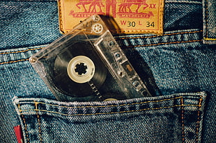clear and black cassette tape in pockey