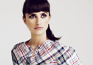 woman in white, red, and blue plaid shirt