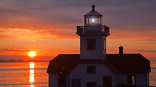 white lighthouse during sunset