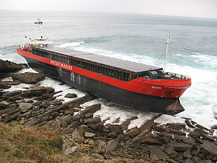 red and black cargo ship, container ship, aground, ship