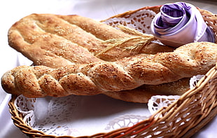 baked bread on round wicker basket