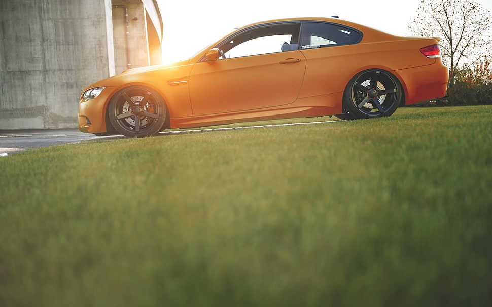 orange coupe, car, orange, grass, blurred HD wallpaper