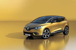 gold Renault Scenic scale model on yellow surface