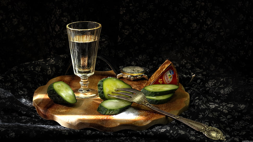 sliced cucumber with stainless steel fork and footed wine glass full-filled with clear liquid on wooden slab HD wallpaper