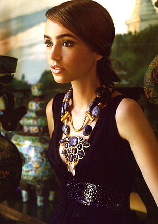 woman in black dress leaning on cabinet beside vases HD wallpaper