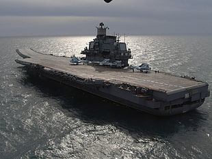 gray warship carrier at the ocean