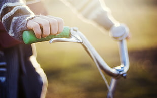 selective focus photography of person riding bicycle