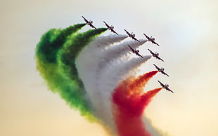photography of jet doing air show spraying green, white, and red smoke represents Italy