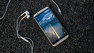 gray Android smartphone with Apple EarBuds HD wallpaper