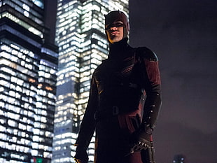daredevil standing near building during nighttime