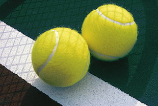 two green tennis balls HD wallpaper