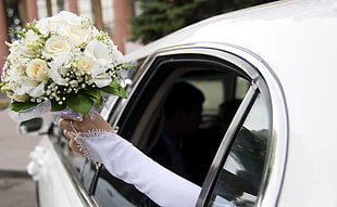 bride holding white Rose flowers bouquet