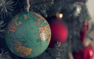 world map printed bauble hanging on Christmas tree HD wallpaper