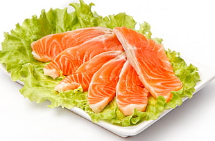 sliced raw salmon with lettuce on white ceramic plate HD wallpaper