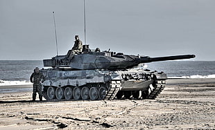 photo of gray war tanks with two soldiers