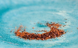 brown ingredients powder on blue surface