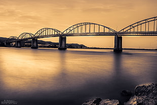 silhouette photo of concrete bridge above calm body of water, portugal