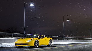 yellow Ferrari 458 Italia at night during snow