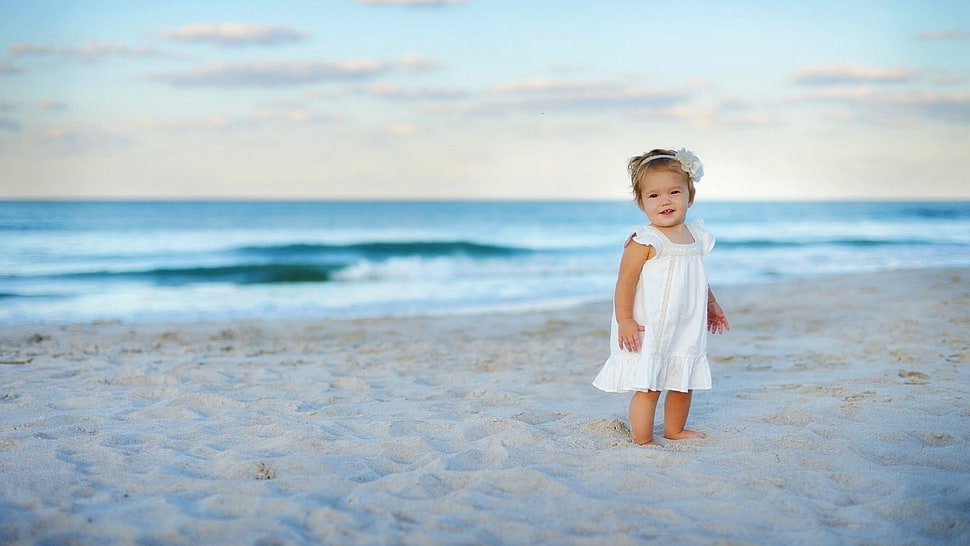 girl standing on the beach during daytime HD wallpaper