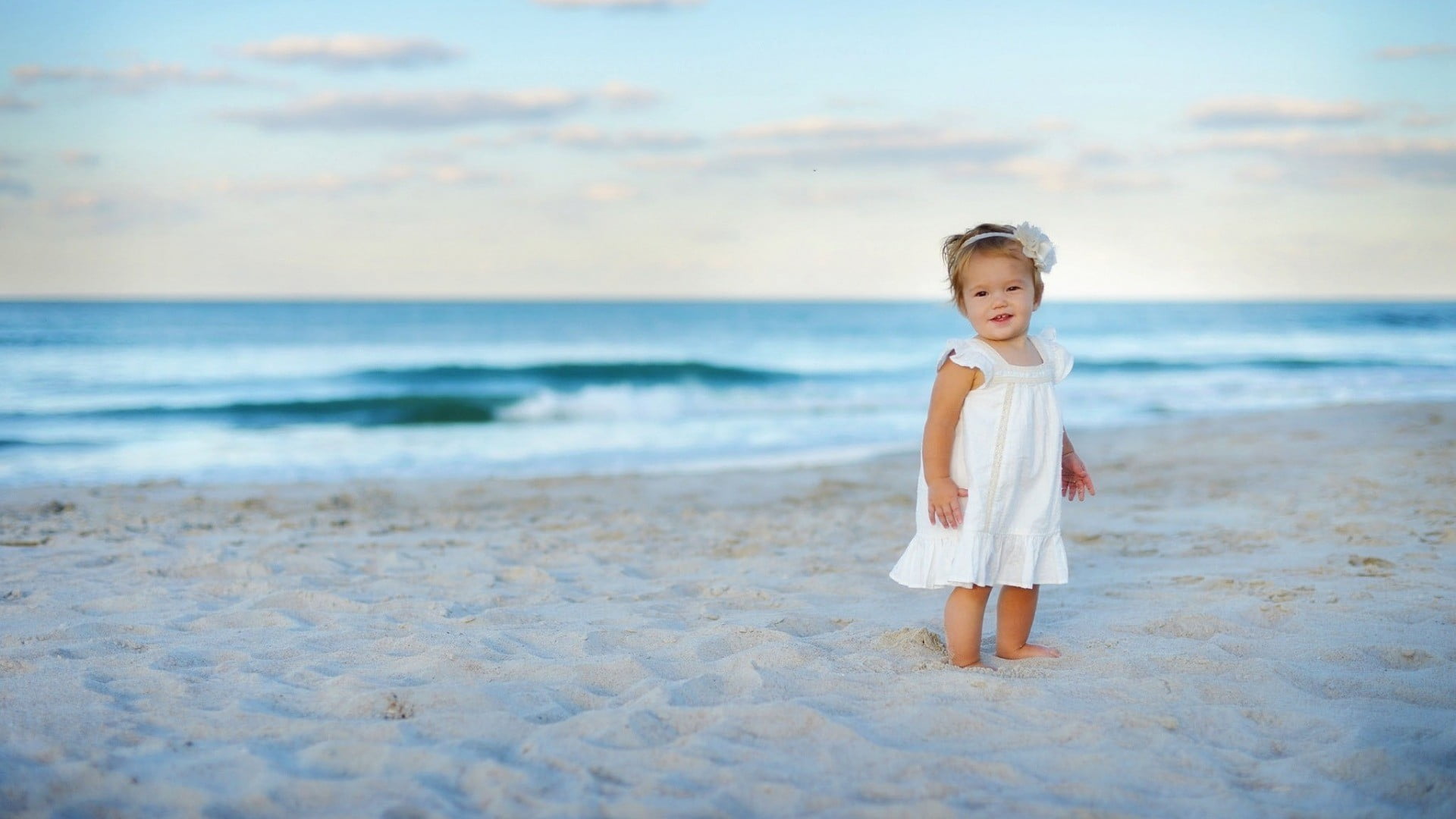 girl standing on the beach during daytime