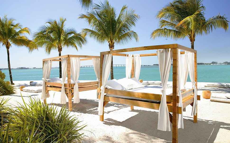 brown-and-white outdoor bed sets on beach during day time HD wallpaper