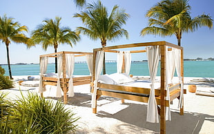 brown-and-white outdoor bed sets on beach during day time