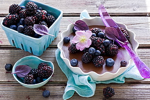 blueberry and raspberry fruit on crate and tray