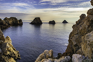 photography of body of water and rock formation, tas