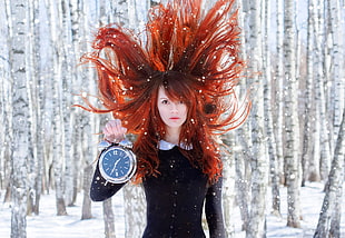 girl with brown hair holding clock