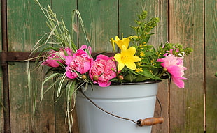 grey metal bucket with pink Peony and yellow Lily flowers