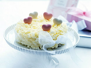 yellow and pink cake on silver cake tray