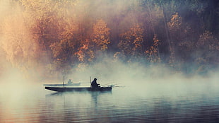 two men riding on boats fishing
