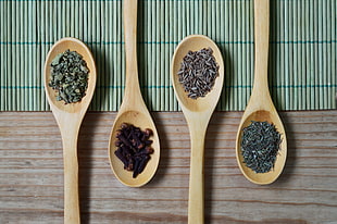 four brown wooden spoons
