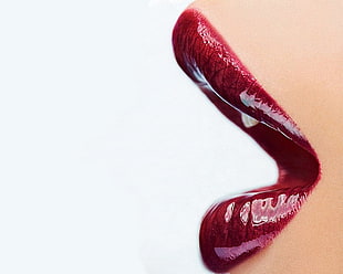 closeup photo of woman's lip with red lipstick