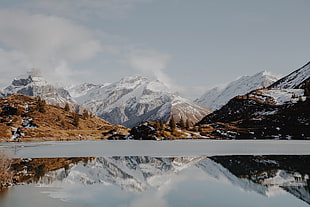 body of water with snow mountain background HD wallpaper