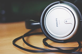 gray Philips headphones on table top