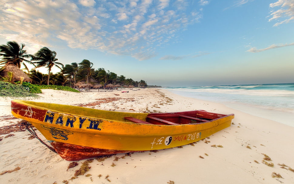 photo of orange and red kayak on seashore during daylight HD wallpaper