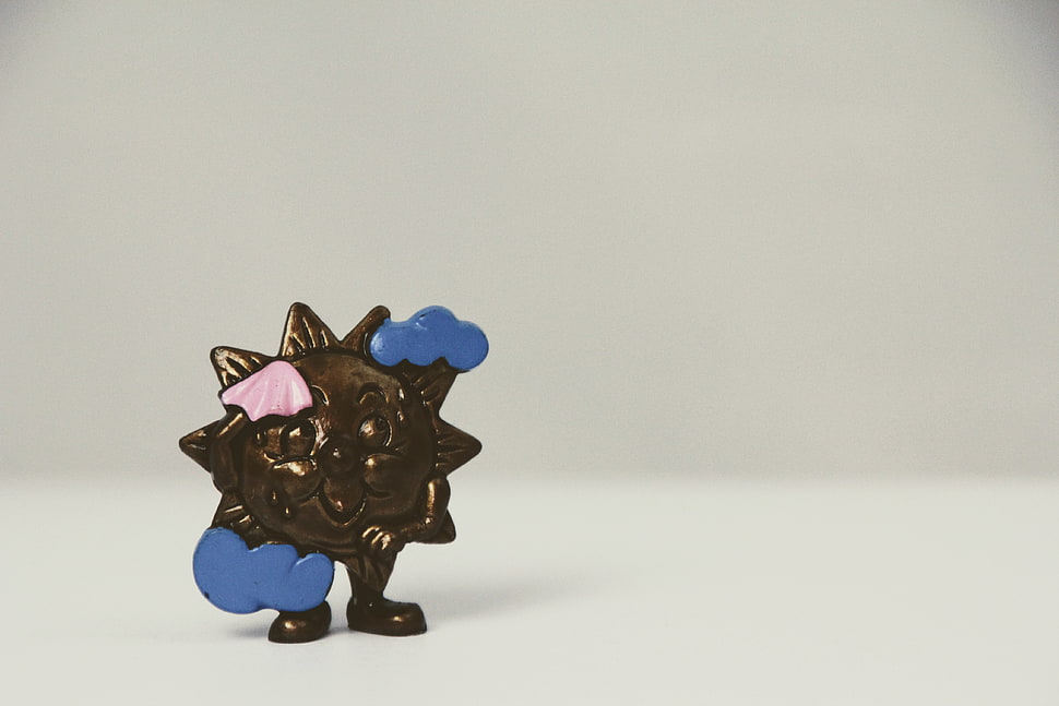 sun-themed brass collectible figure HD wallpaper