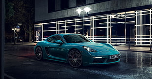blue Porsche Cayman S on street during night time