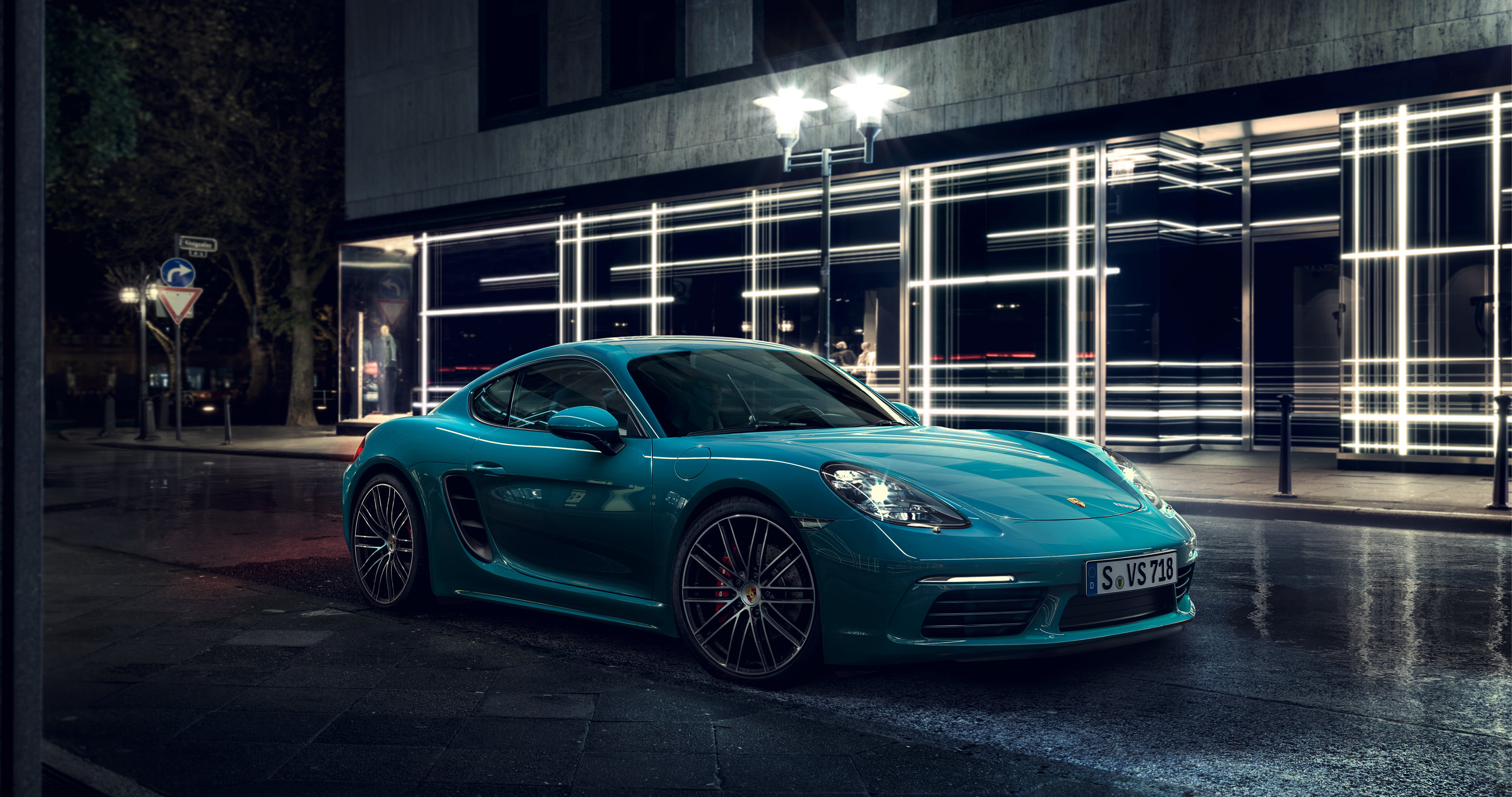 blue Porsche Cayman S on street during night time
