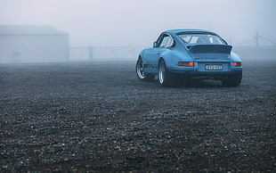 blue Porsche 911 under parked