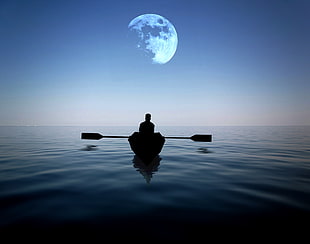 man riding on a boat alone in the sea with moon hovering above at night HD wallpaper