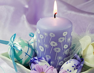 purple and white floral wax candle