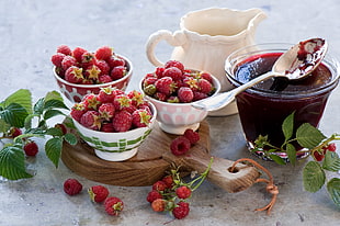 photography of three cups of strawberries near one cup of strawberry jam