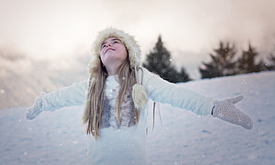 girl in white sweater standing on snow covered area during daytime HD wallpaper