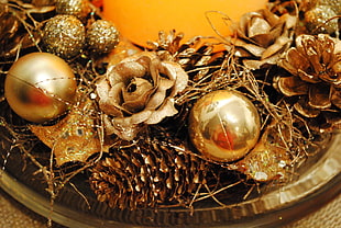 close-up of gold-colored baubles and pine cones